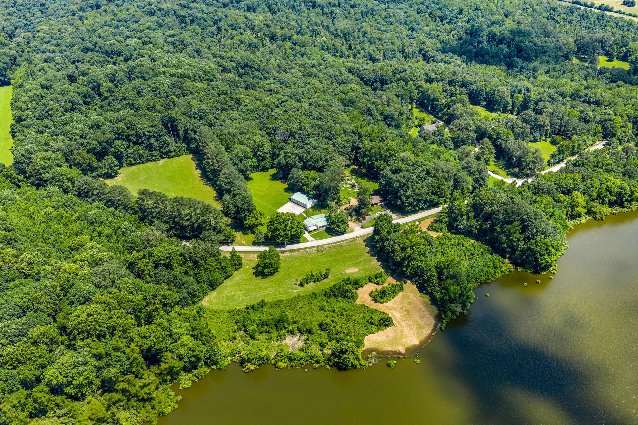 196 Wildlife Road Dover, TN 37058 - Photo 91 of 98 an aerial view of a house with a yard and lake view