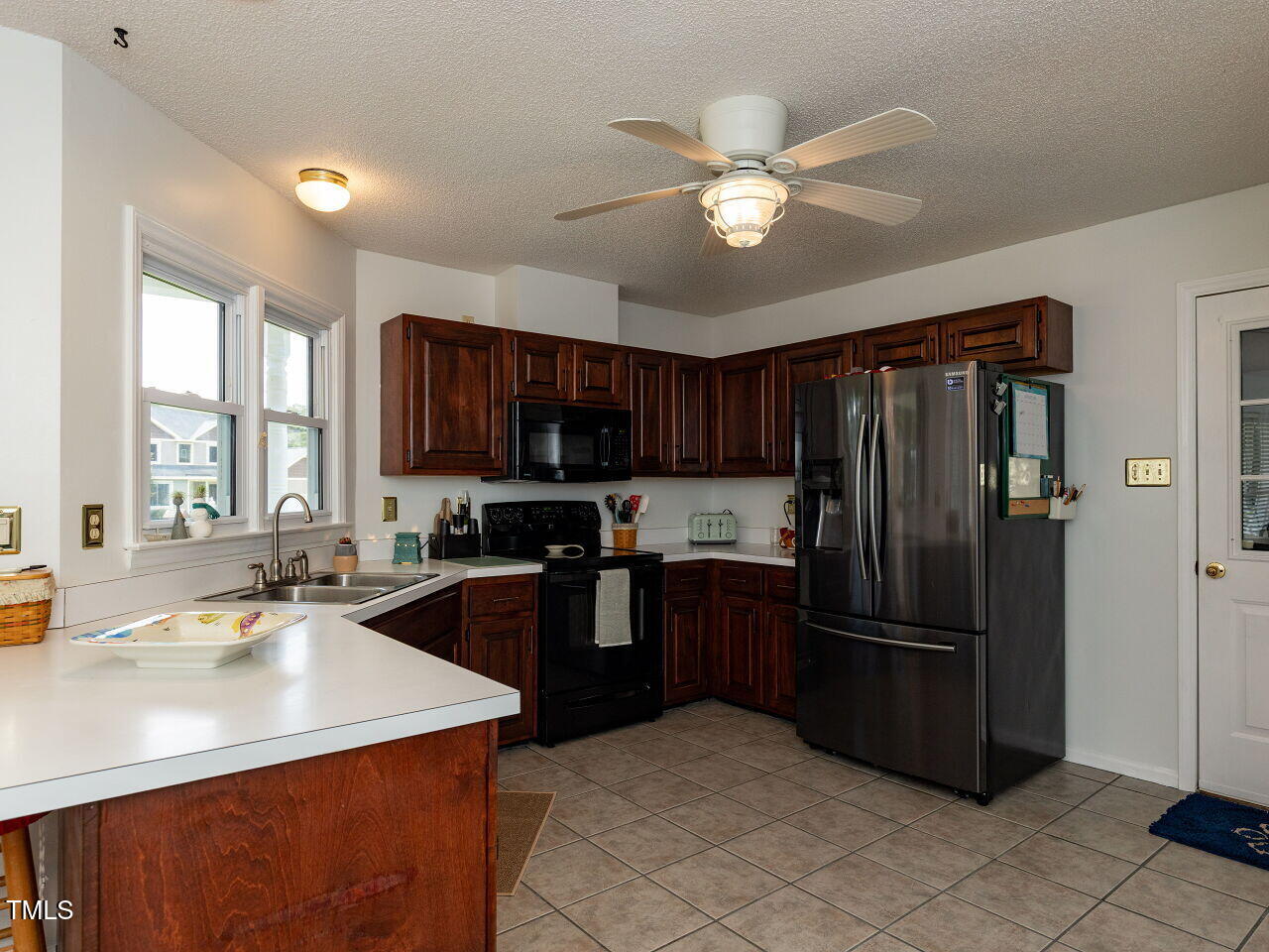 1025 Lake Path Road Willow Spring, NC 27592 - Photo 10 of 30 a kitchen with stainless steel appliances granite countertop a sink refrigerator and cabinets