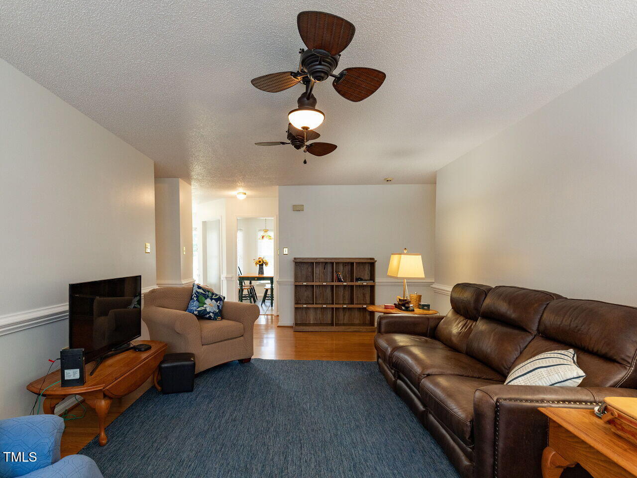 1025 Lake Path Road Willow Spring, NC 27592 - Photo 12 of 30 a living room with furniture a ceiling fan and a window