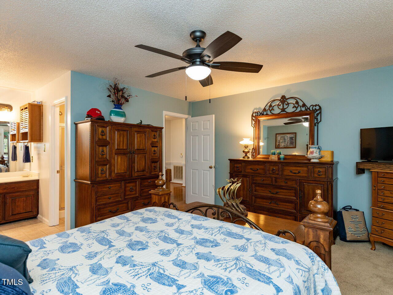 1025 Lake Path Road Willow Spring, NC 27592 - Photo 14 of 30 a bedroom with a bed and a chandelier