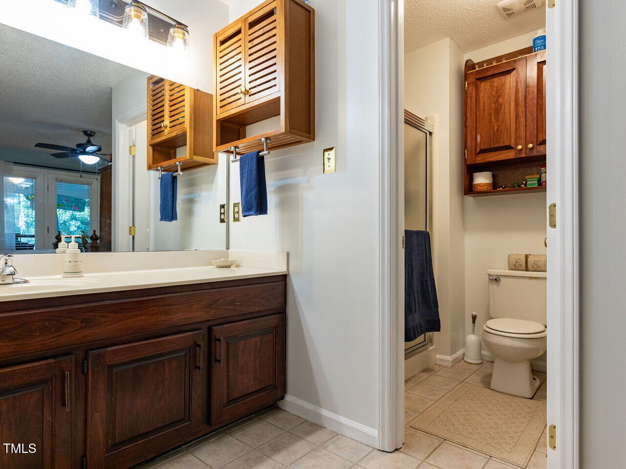 1025 Lake Path Road Willow Spring, NC 27592 - Photo 15 of 30 a bathroom with a granite countertop sink a toilet and a mirror