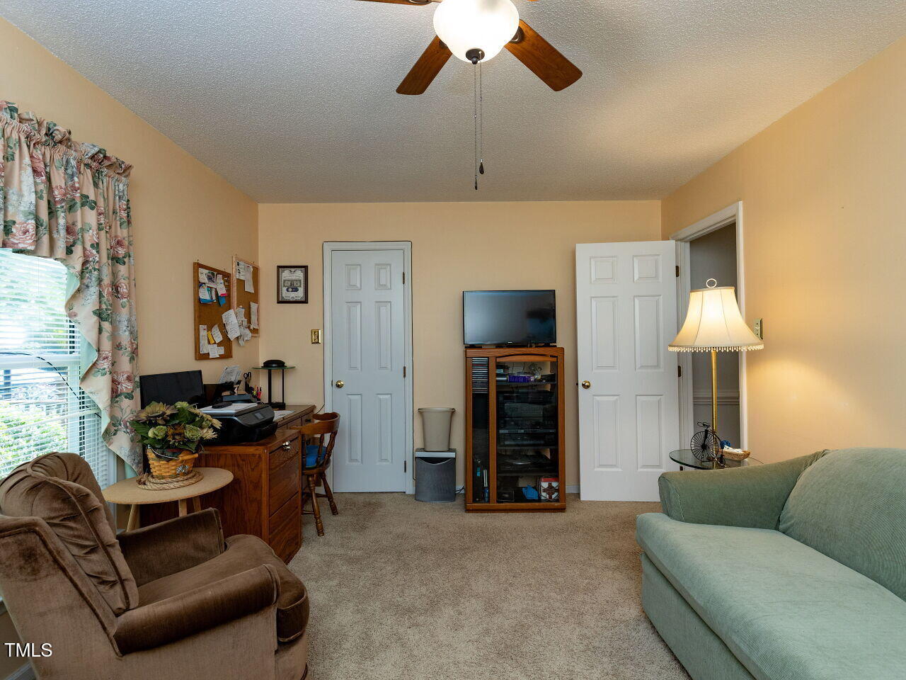 1025 Lake Path Road Willow Spring, NC 27592 - Photo 19 of 30 a living room with furniture and a flat screen tv