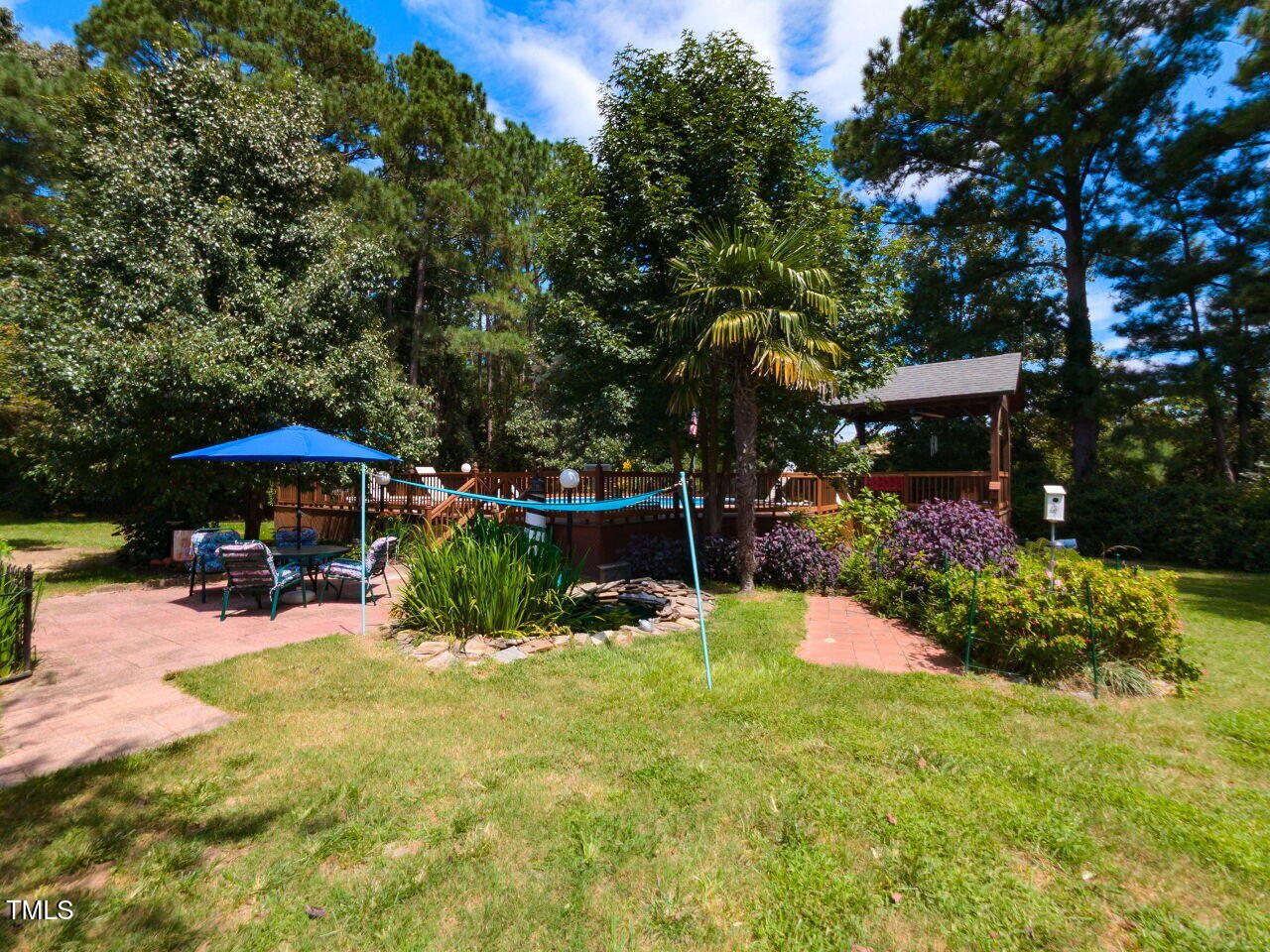 1025 Lake Path Road Willow Spring, NC 27592 - Photo 27 of 30 a view of a chair and table under an umbrella