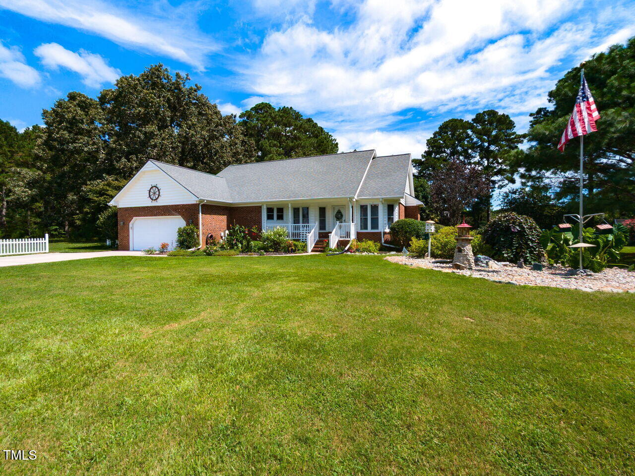 1025 Lake Path Road Willow Spring, NC 27592 - Photo 2 of 30 a front view of a house with garden