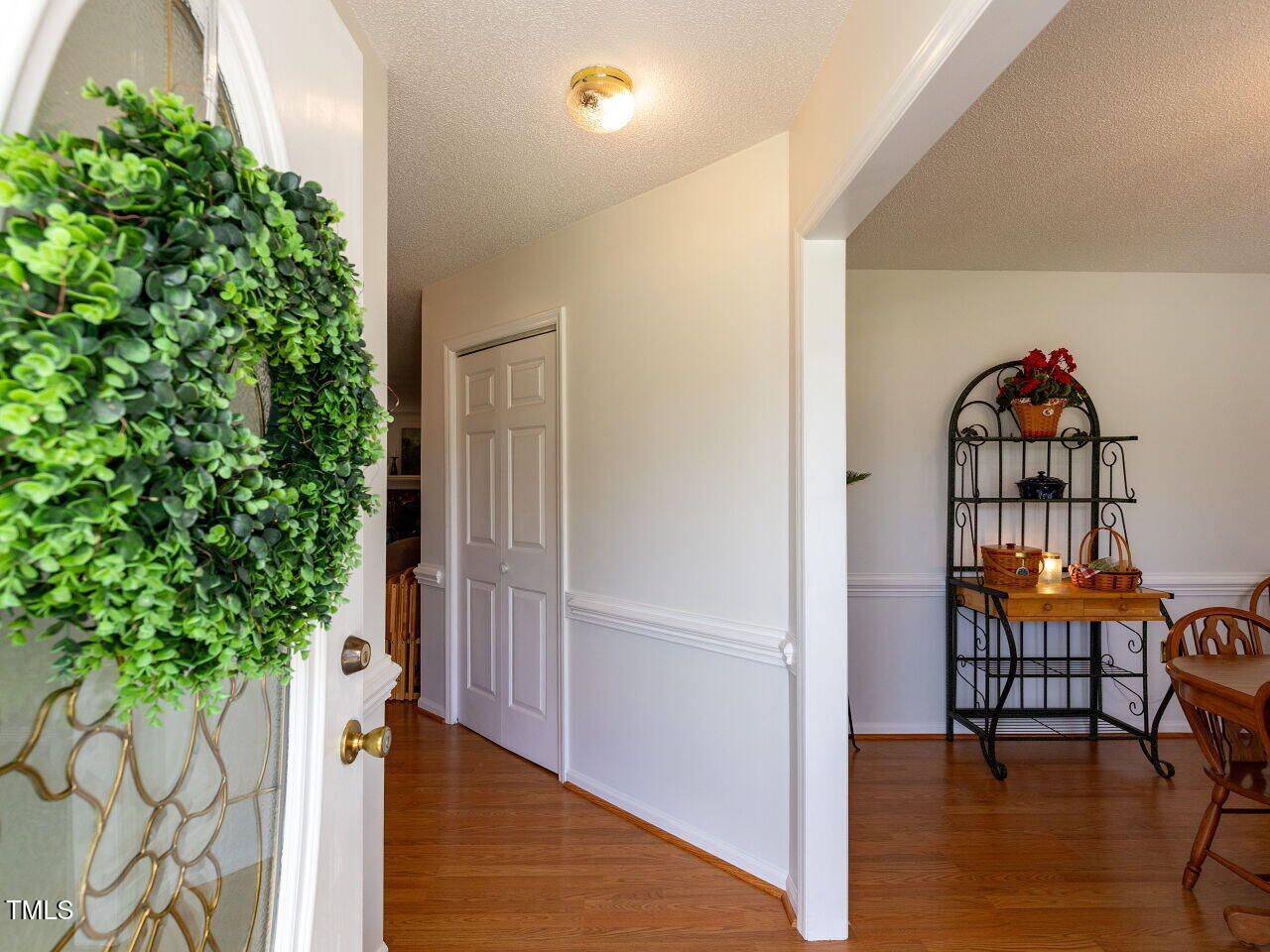 1025 Lake Path Road Willow Spring, NC 27592 - Photo 6 of 30 an empty room with potted plants and wooden floor