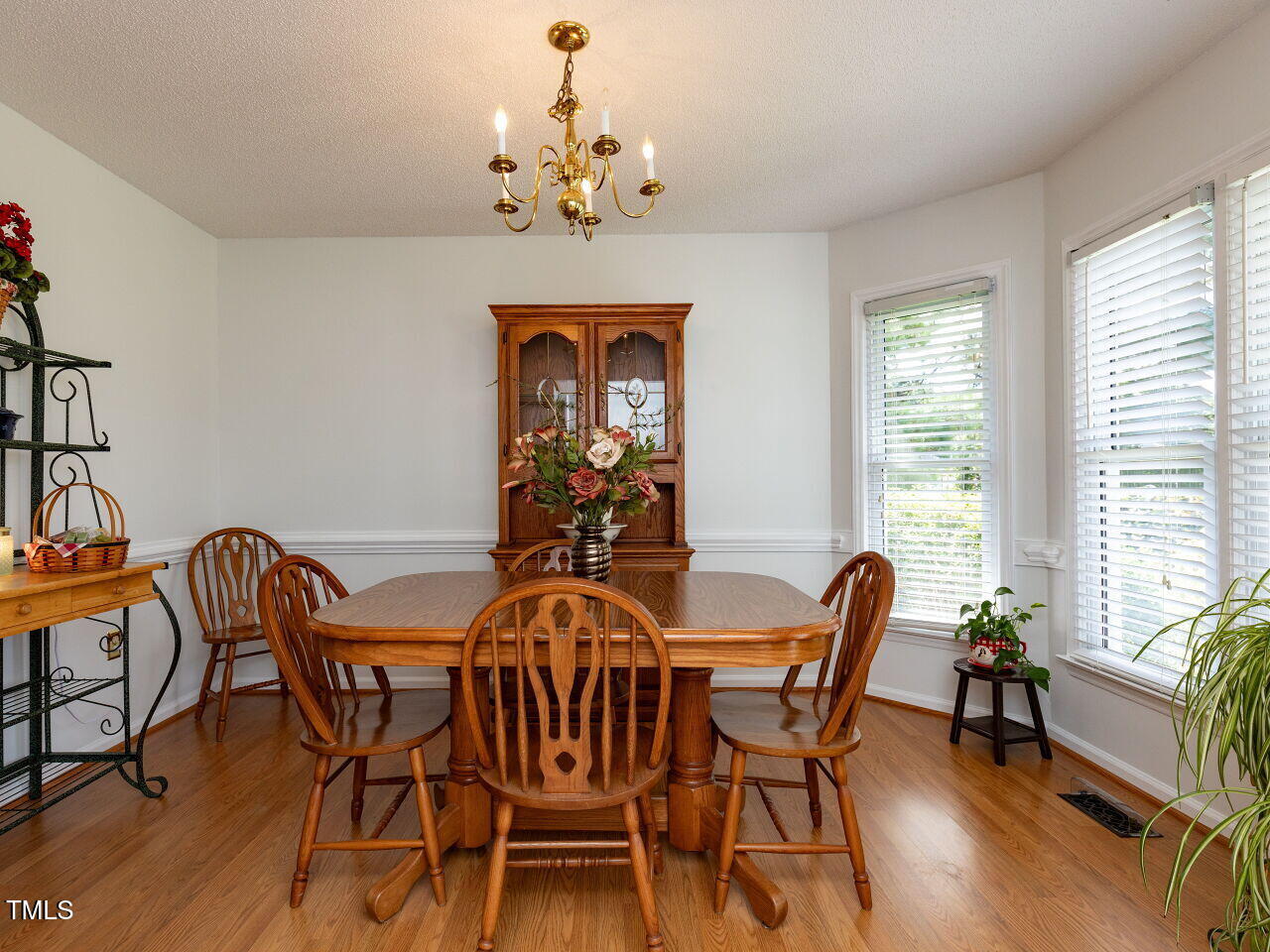 1025 Lake Path Road Willow Spring, NC 27592 - Photo 7 of 30 a view of a dining room with furniture a chandelier and wooden floor