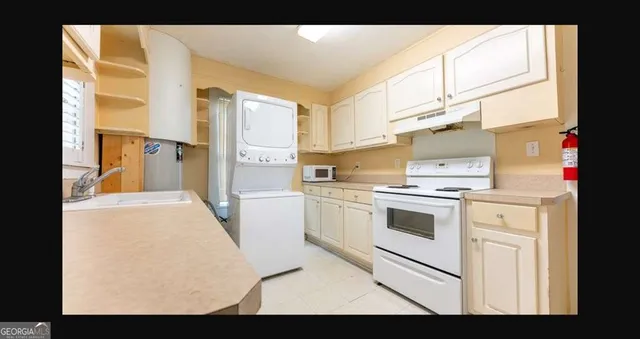 a kitchen with stainless steel appliances kitchen island granite countertop a stove a sink and a refrigerator
