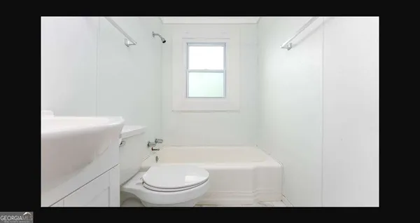 a bathroom with a toilet and a bathtub
