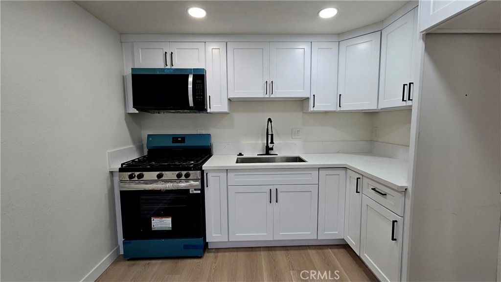 15917 Prairie Avenue, Unit 2 Lawndale, CA 90260 - Photo 3 of 10 a kitchen with white cabinets and stainless steel appliances