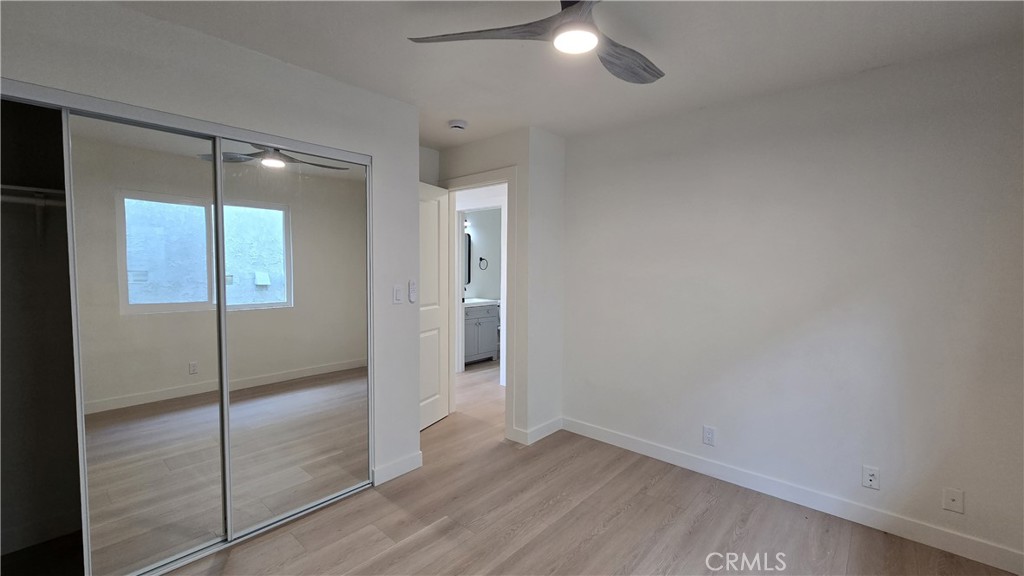 15917 Prairie Avenue, Unit 2 Lawndale, CA 90260 - Photo 7 of 10 an empty room with wooden floor and mirror