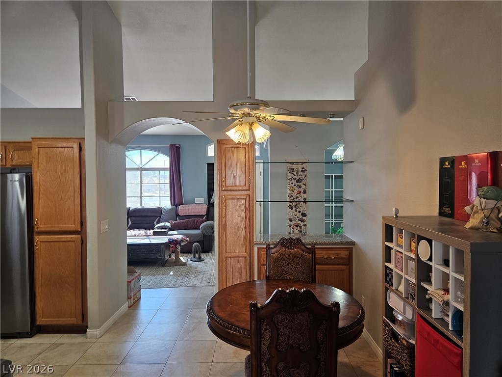 Tiled floors and soaring vaulted ceilings connect the dining space directly to the main living area.