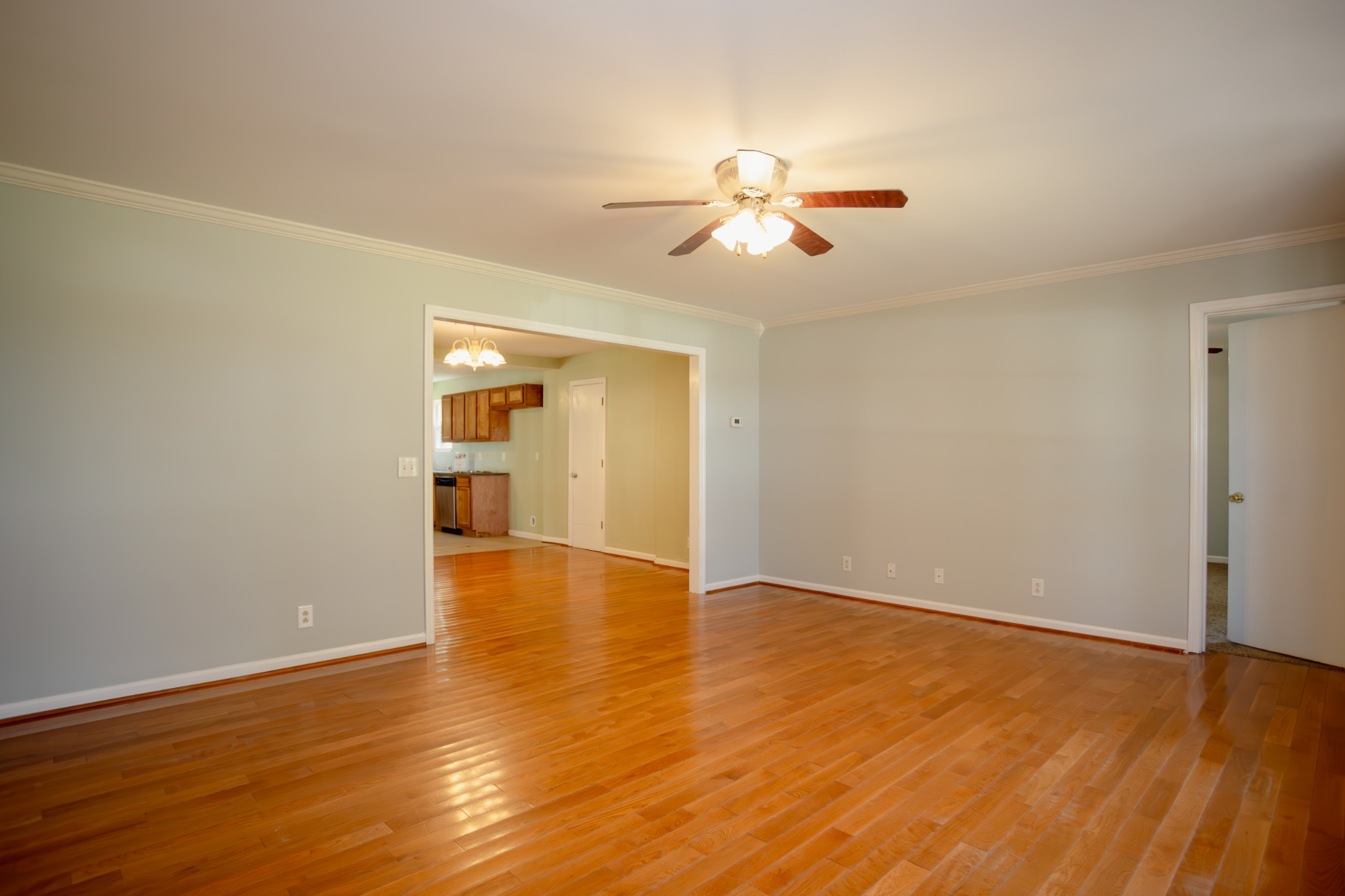 1052 Randy Road Ashland City, TN 37015 - Photo 5 of 30 a view of an empty room with wooden floor and a ceiling fan