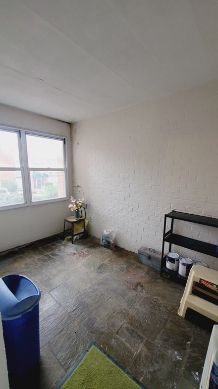 7 Commonwealth Court, Unit 5 Boston, MA 02135 - Photo 16 of 19 a view of a room with gym equipment and a window
