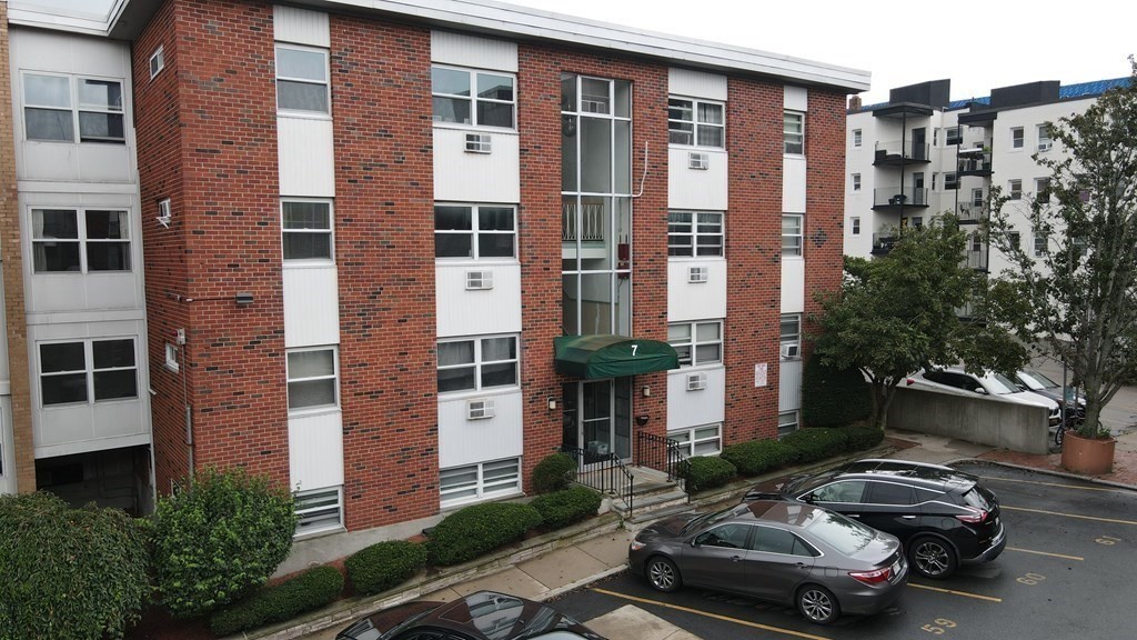 7 Commonwealth Court, Unit 5 Boston, MA 02135 - Photo 2 of 19 a car parked in front of a brick building