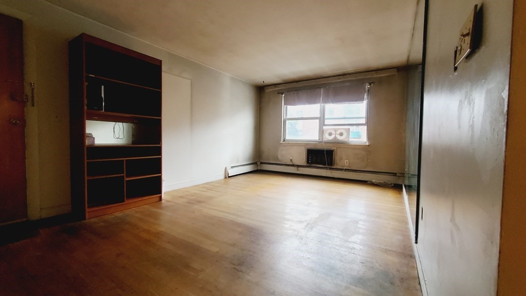 7 Commonwealth Court, Unit 5 Boston, MA 02135 - Photo 4 of 19 an empty room with windows and cabinet