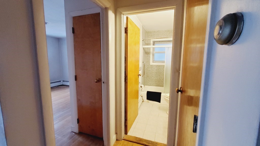 7 Commonwealth Court, Unit 5 Boston, MA 02135 - Photo 6 of 19 a view of a bathroom from a hallway