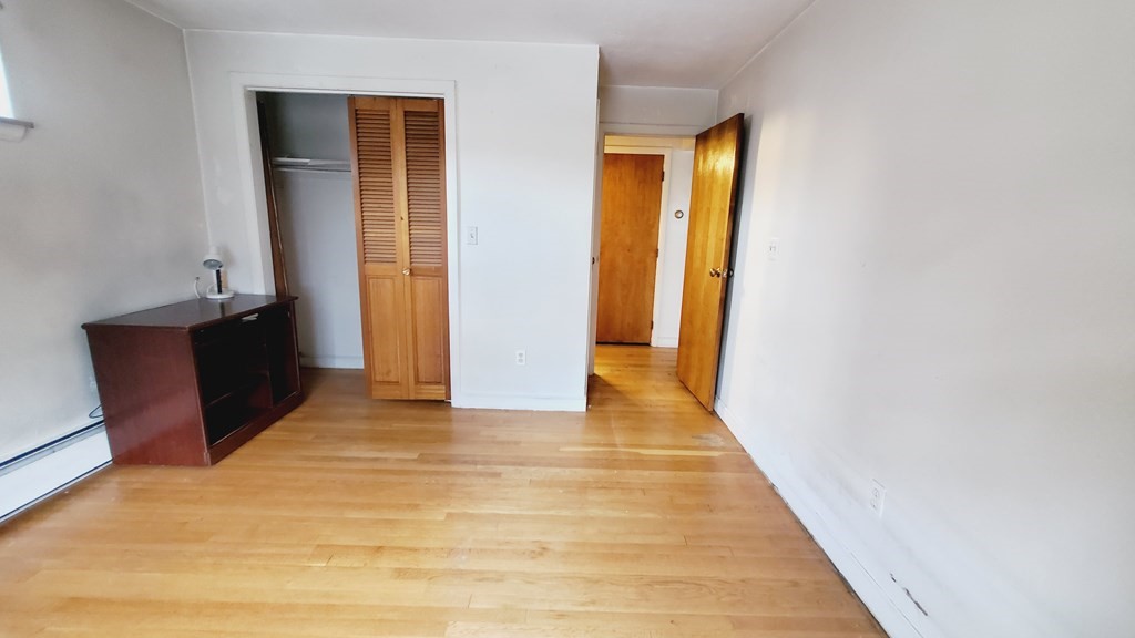 7 Commonwealth Court, Unit 5 Boston, MA 02135 - Photo 8 of 19 a view of a hallway with wooden floor and closet