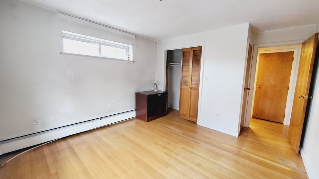 7 Commonwealth Court, Unit 5 Boston, MA 02135 - Photo 9 of 19 a view of an empty room with wooden floor