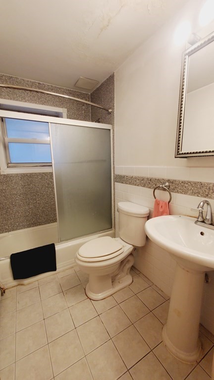 7 Commonwealth Court, Unit 5 Boston, MA 02135 - Photo 10 of 19 a bathroom with a sink a toilet and shower