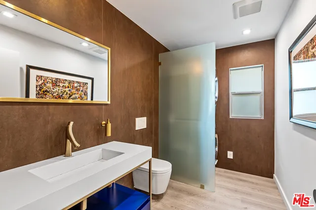 a bathroom with a sink a toilet and mirror