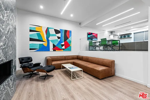 a living room with furniture and painting on the wall