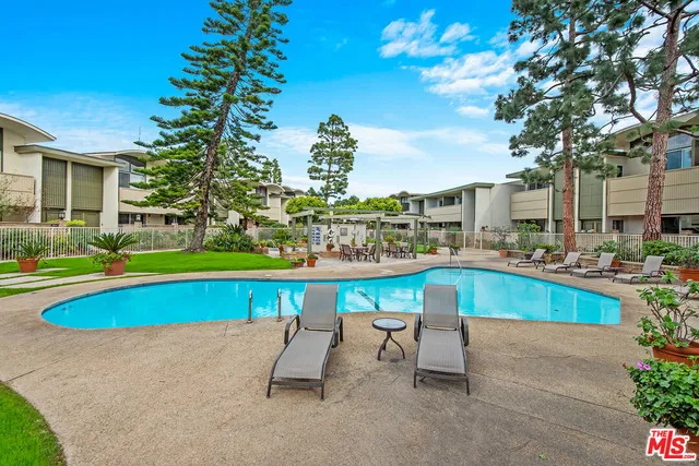 a view of swimming pool with outdoor seating and yard