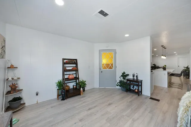 a living room with furniture window and wooden floor