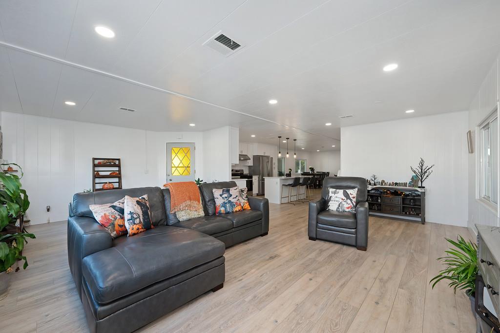 7512 Bufflehead Lane Citrus Heights, CA 95621 - Photo 2 of 52 a living room with furniture kitchen view and a wooden floor