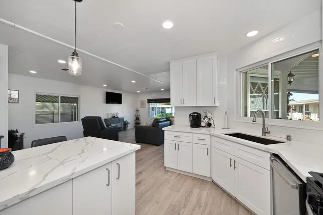 a kitchen with furniture and a wooden floor