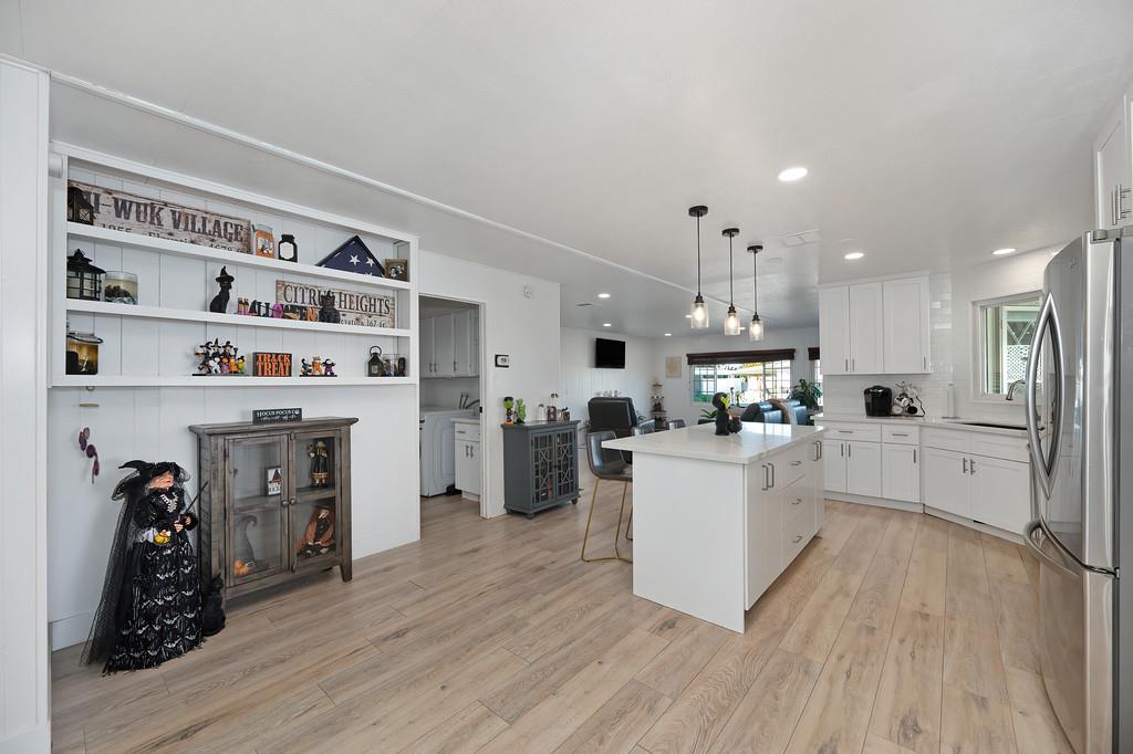 7512 Bufflehead Lane Citrus Heights, CA 95621 - Photo 24 of 52 a kitchen with furniture and a wooden floor