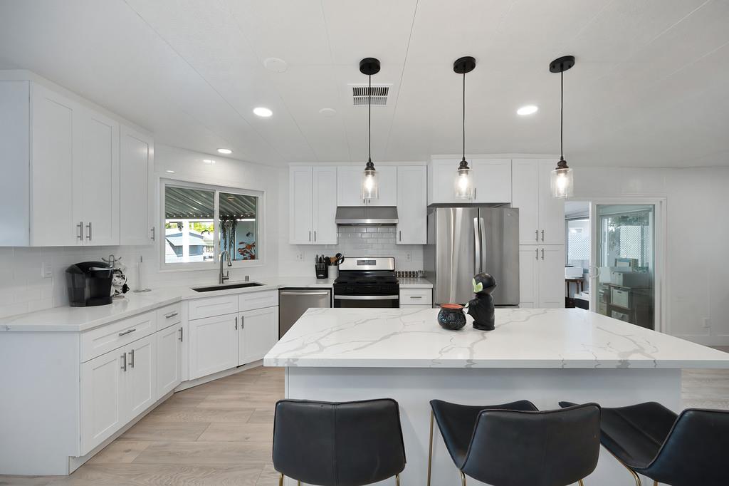 7512 Bufflehead Lane Citrus Heights, CA 95621 - Photo 28 of 52 a kitchen with stainless steel appliances kitchen island granite countertop a sink a stove and a refrigerator