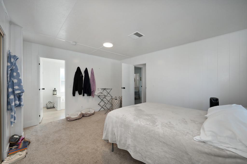7512 Bufflehead Lane Citrus Heights, CA 95621 - Photo 30 of 52 a bedroom with a bed and a white wall