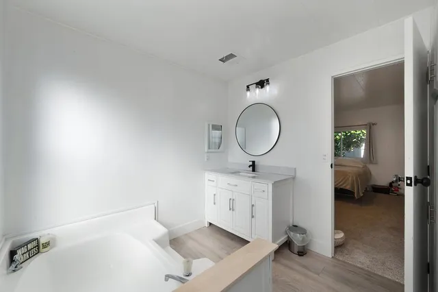 a bathroom with a toilet a sink and a mirror