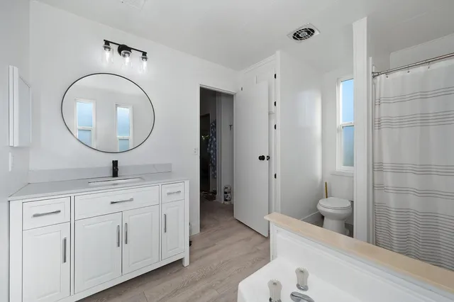 a bed sitting in a room next to a window