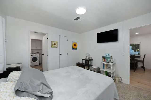 a bedroom with a bed and a window