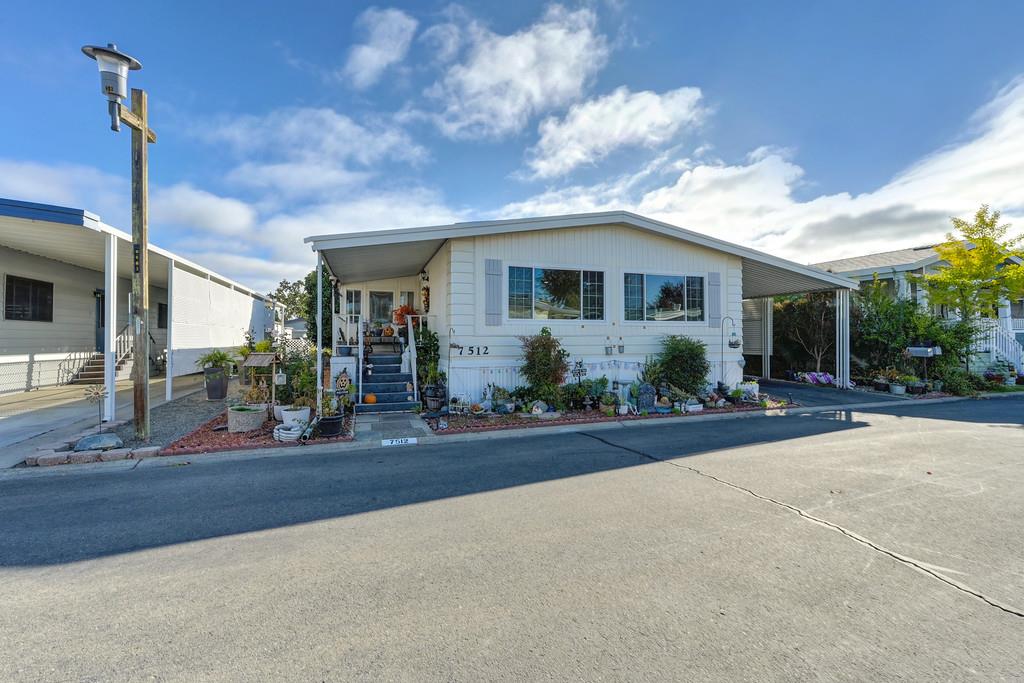 7512 Bufflehead Lane Citrus Heights, CA 95621 - Photo 6 of 52 a view of a house with potted plants and a large tree