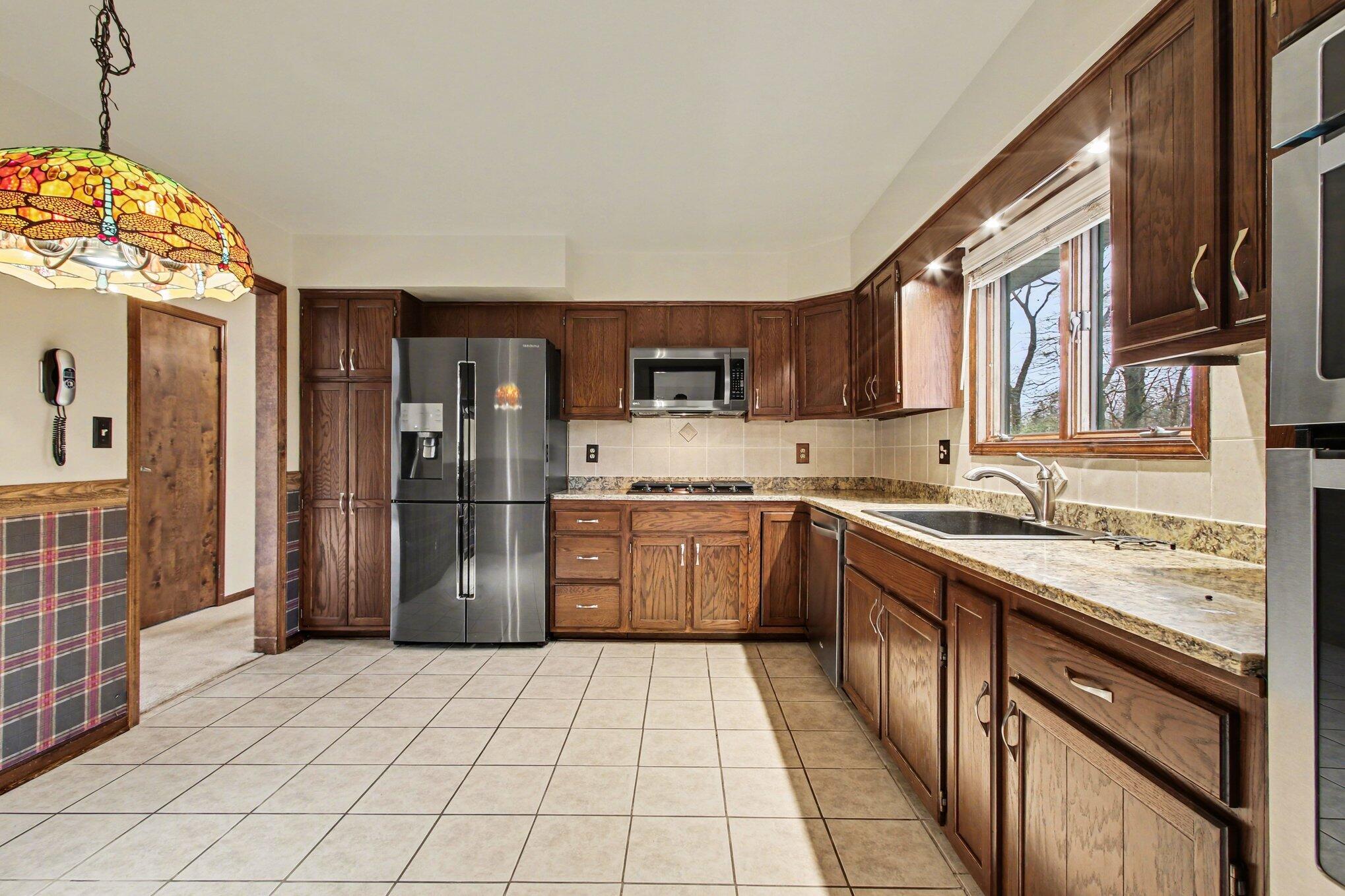 186 Wexford Road Valparaiso, IN 46385 - Photo 7 of 33 a kitchen with stainless steel appliances granite countertop a refrigerator and a sink