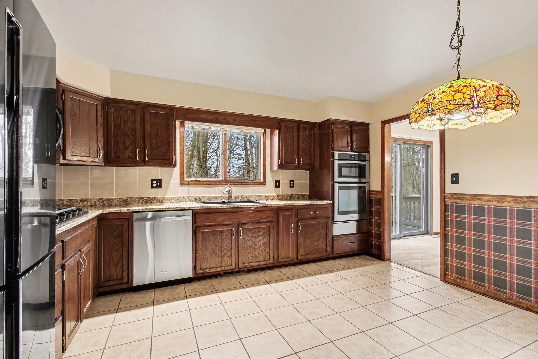186 Wexford Road Valparaiso, IN 46385 - Photo 8 of 33 a kitchen with stainless steel appliances granite countertop a refrigerator and a sink