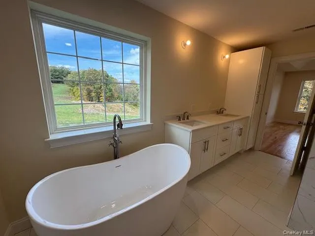 a white bath tub sitting next to a window