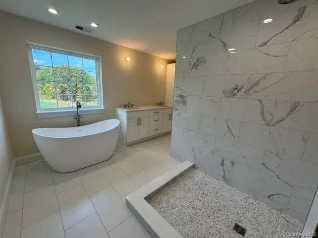 a spacious bathroom with a bathtub and window