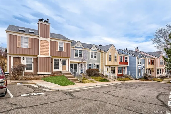 a front view of a residential apartment building with a yard