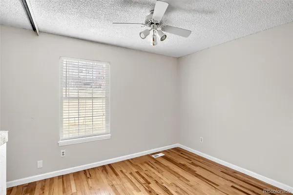 a view of a room with window and ceiling fan