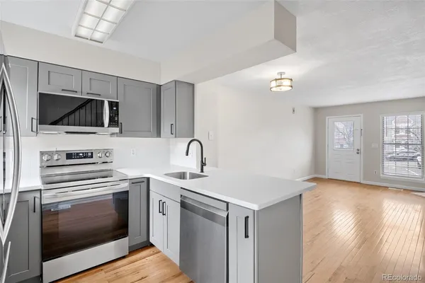 a kitchen with a sink stainless steel appliances and cabinets