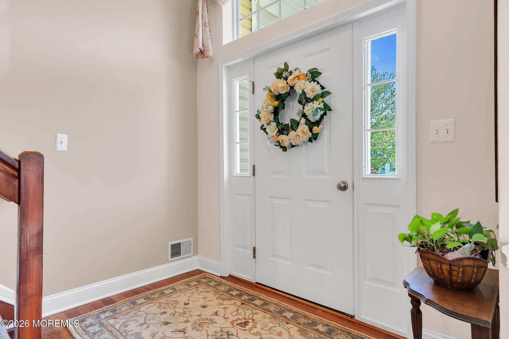 343 Nighthawk Lane Jackson, NJ 08527 - Photo 12 of 72 a view of a hallway with wooden floor and a potted plant
