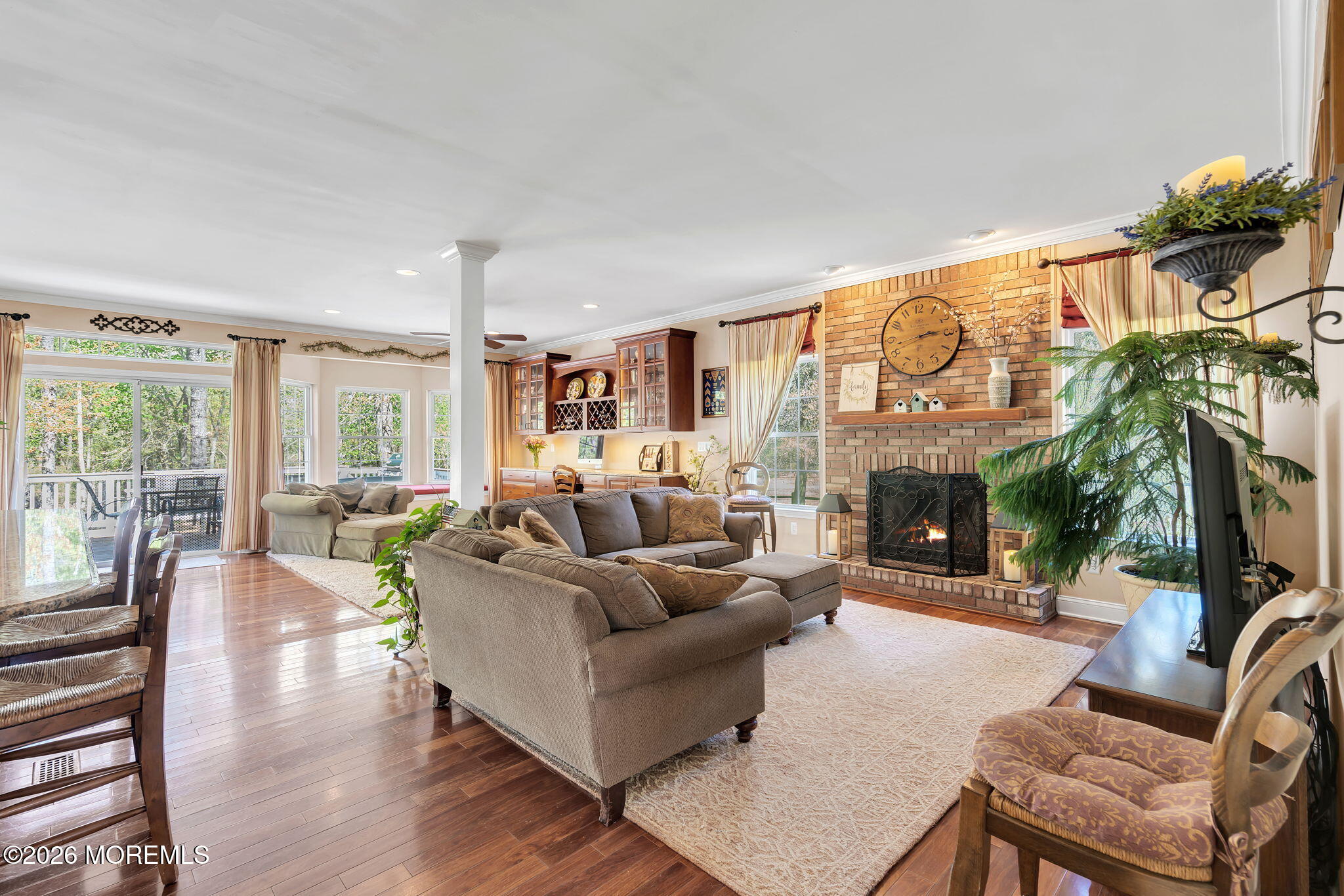343 Nighthawk Lane Jackson, NJ 08527 - Photo 34 of 72 a living room with furniture a fireplace and a floor to ceiling window