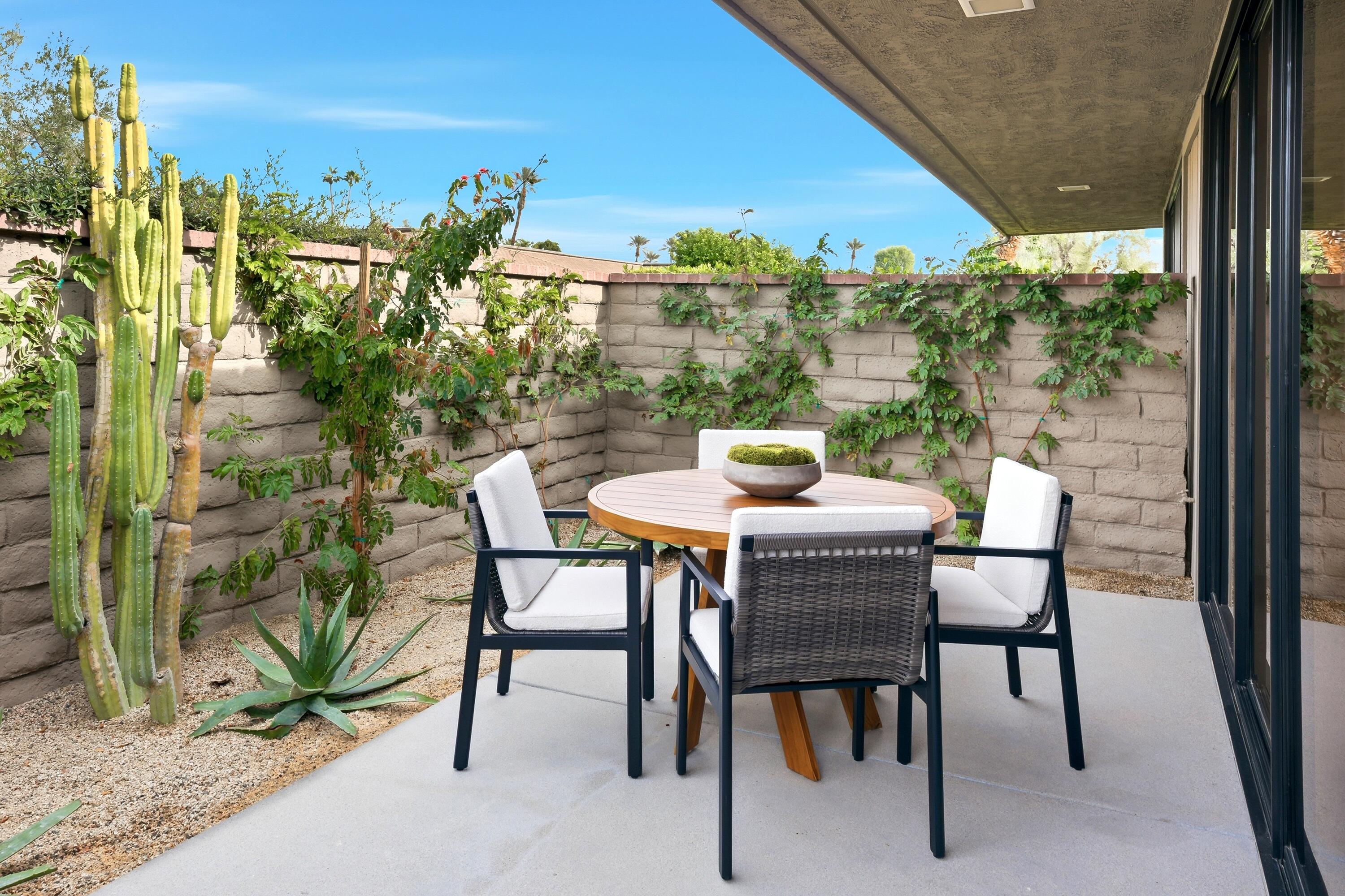 14 Rutgers Court Rancho Mirage, CA 92270 - Photo 21 of 59 a dining room with furniture and a garden