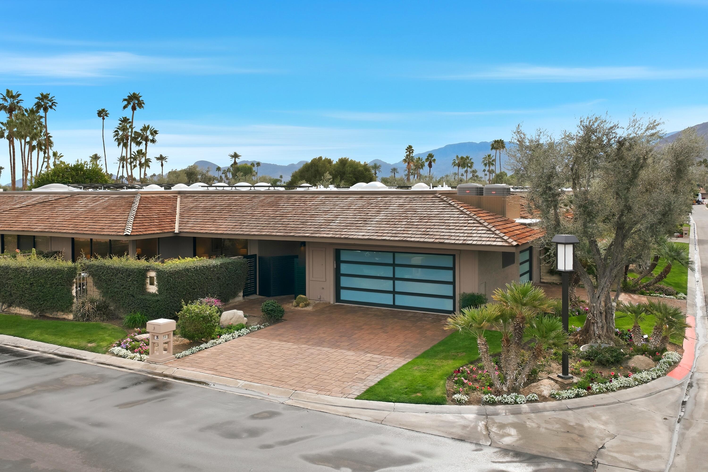 14 Rutgers Court Rancho Mirage, CA 92270 - Photo 9 of 59 a front view of a house with a yard and potted plants