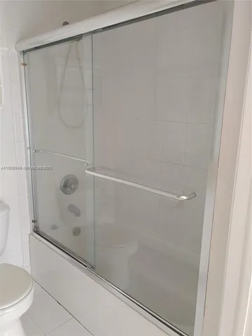 a bathroom with a shower and a toilet