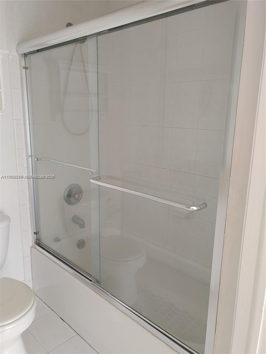 7510 Northwest 175th Street, Unit 7510 Hialeah, FL 33015 - Photo 11 of 14 a bathroom with a shower and a toilet