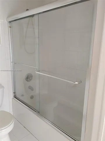 a bathroom with a shower and a toilet